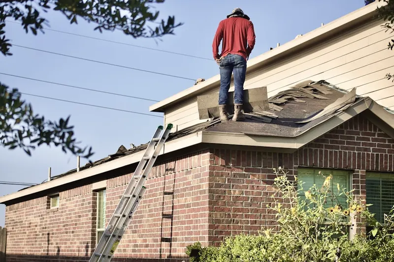 Professional roofer working on a residential roof in Waynewood